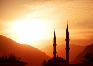 Mosque silhouette at sunset, with mountains on background, Turkey, Kemer